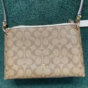 Tan and white coach purse